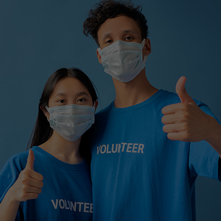 woman and man standing wearing t-shirt saying "volunteer"